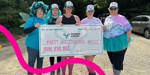 5 runners with a large cheque for donations